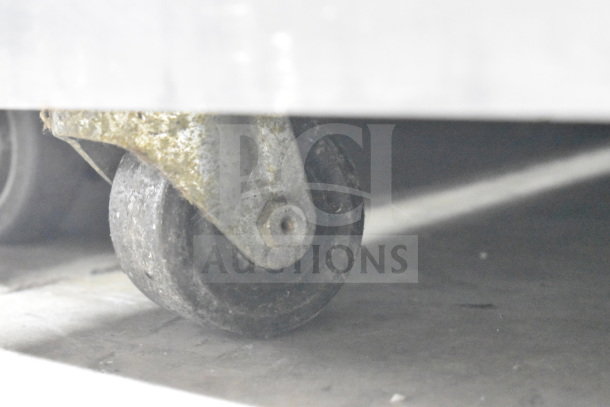Taylor C723-33 ice cream machine caster, showing one wheel in used condition.