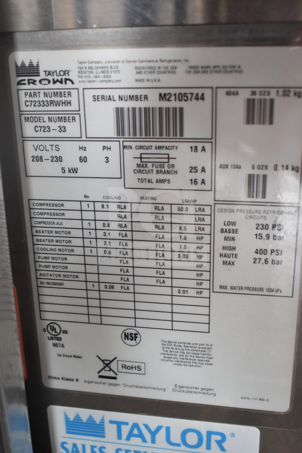 Taylor C723-33 commercial soft serve machine label shows specs: 208-230V, 3 phase, 5kW, NSF, UL listed, RoHS compliant.