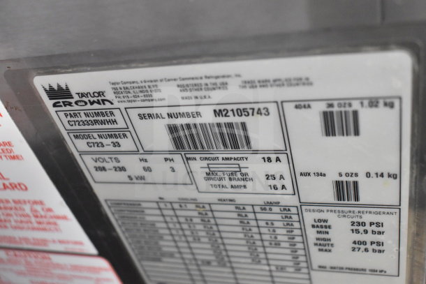 Taylor C723-33 commercial soft serve machine label; 208-230V, 3-phase; serial M2105743; lists electrical specs and design pressures.