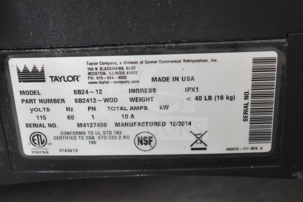 Taylor SB24-12 Frozen Beverage Machine label showing voltage, model, weight, and manufacture date. Made in USA.