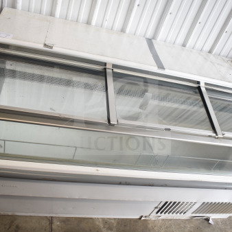 Hussmann LBN-6 ice cream freezer merchandiser, commercial grade, glass sliding top, visible wear, 115V, 1-phase.