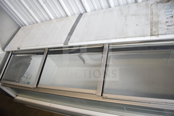 Hussmann LBN-6 commercial novelty ice cream freezer merchandiser, glass panels, 115 volts, visible wear, model label shown.