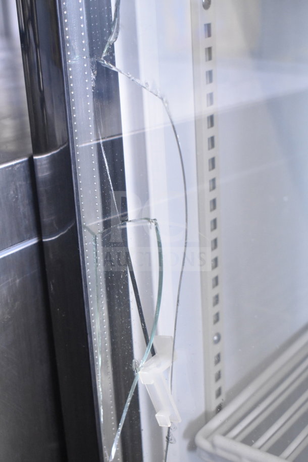 Cooler Depot 2 Door Reach In Cooler with broken glass and commercial casters. Visible shelving and glass damage.