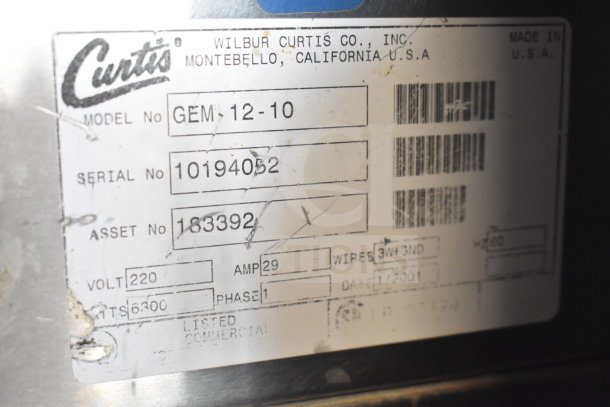 Label of Curtis GEM-12-10 coffee machine showing model, serial number, voltage, and manufacturing date details.