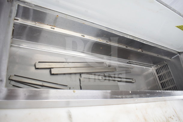 Avantco Commercial Pizza Prep Table, stainless steel interior with adjustable railings, 115V, 1 phase, slightly used condition.
