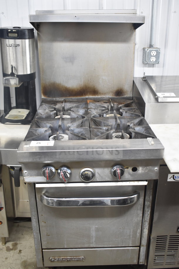 Southbend commercial gas-powered 4 burner range with oven, overshelf, and backsplash. Visible wear on burners and oven door.