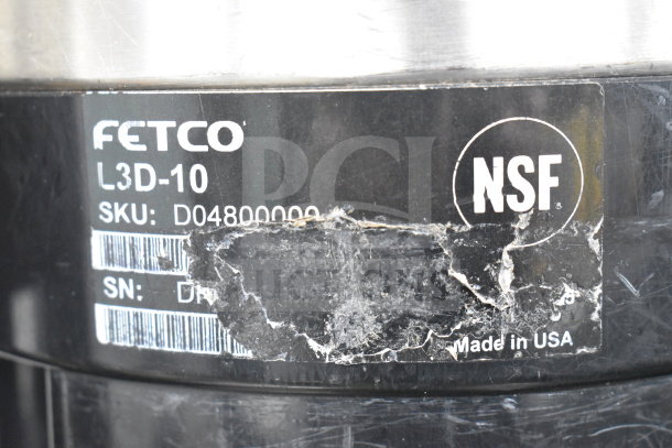 Close-up of Fetco Luxus L3D-10 label showing SKU D04800000 and NSF certification, indicating USA manufacturing.