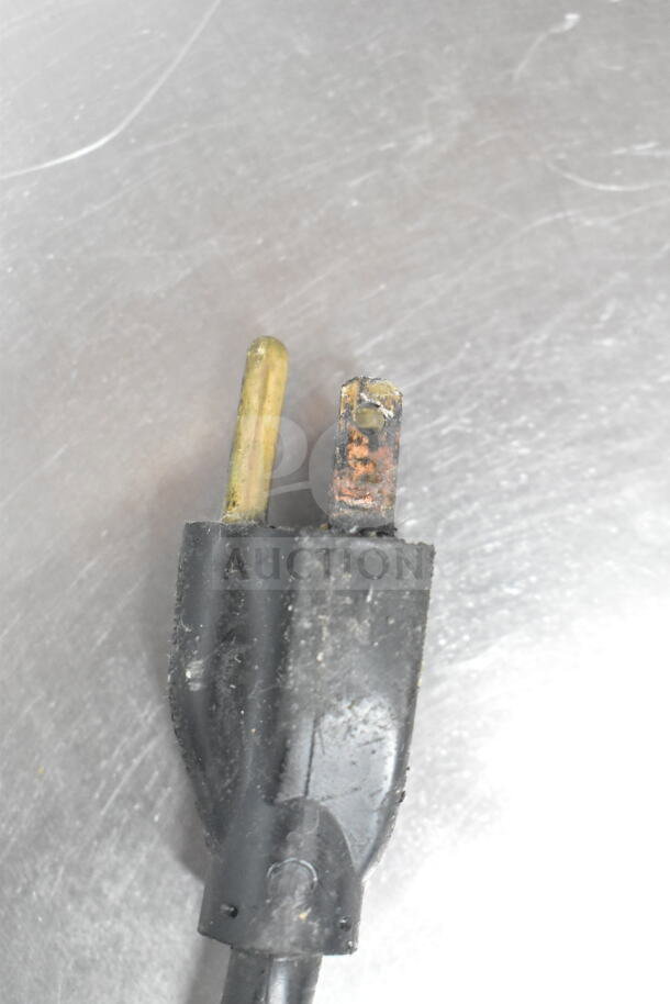 Close-up of a power plug for the Belleco JT1-H Commercial Conveyor Toaster Oven. Plug shows wear and oxidation.
