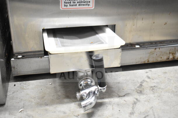 YF-SY80 Manual Sugar Cane Juice Extractor, stainless steel, with hand crank and spout, moderate wear, caution label visible.