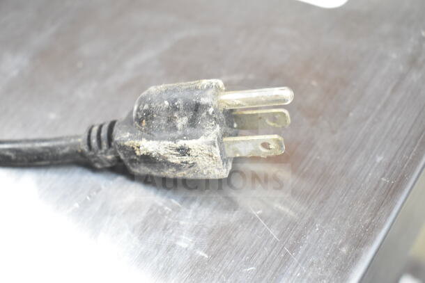 Close-up of a power plug from a 2018 Bunn CW15-APS commercial coffee machine, showing wear and dirt.