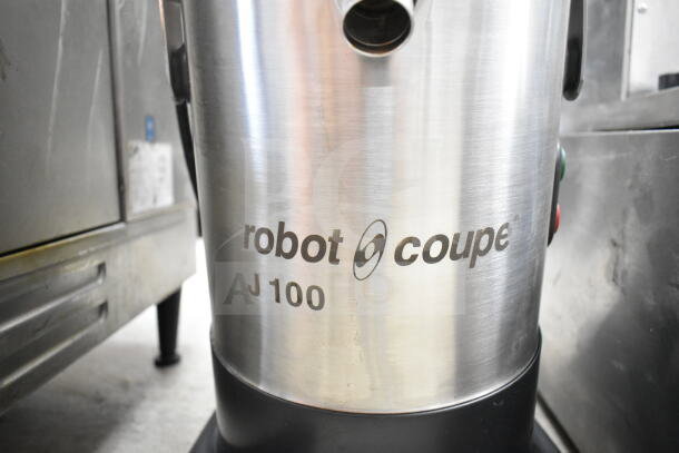 Robot Coupe J100 commercial juicer, 115 volts, 1 phase, stainless steel body, logo and model number visible.