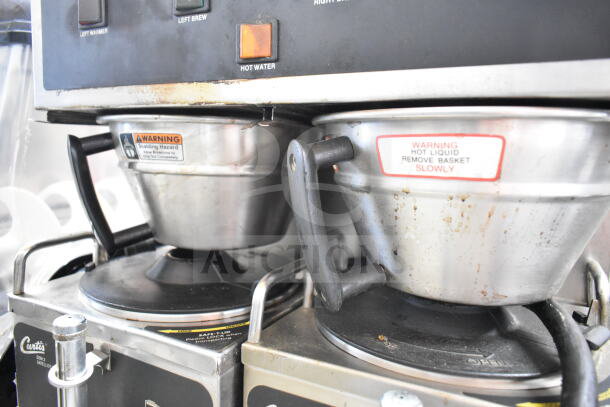 Curtis GEM-12-10 commercial double coffee machine with two server satellites, brew baskets shown; warning labels visible.