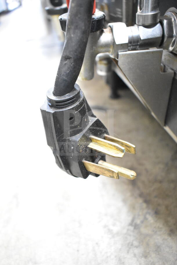 Close-up of a power plug for the Curtis GEM-12-10 commercial coffee machine, suited for 220 volts, 1 phase connection.