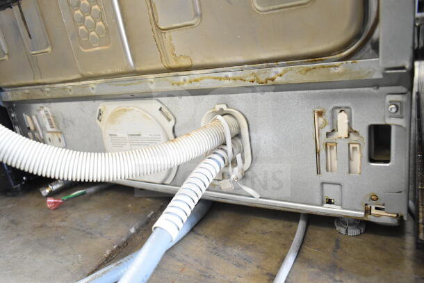 Miele undercounter dishwasher, 115 volts, 1 phase, showing bottom panel with visible water stains and connections.