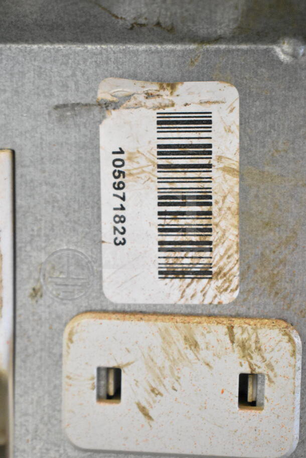Barcode label on Miele Undercounter Dishwasher, model 115 volts, 1 phase, showing item number 105971823. Marks indicate prior use.