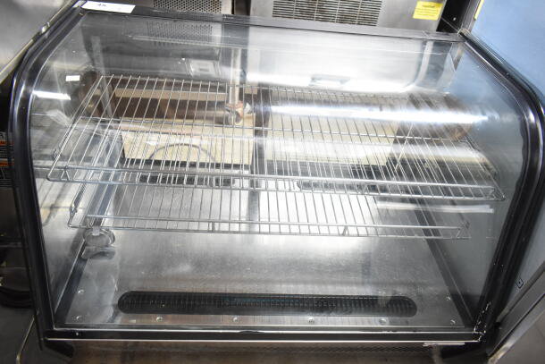 Omcan 27157 countertop refrigerated display case, model 27157, with two shelves, 110 volts, 1 phase, in near-new condition.
