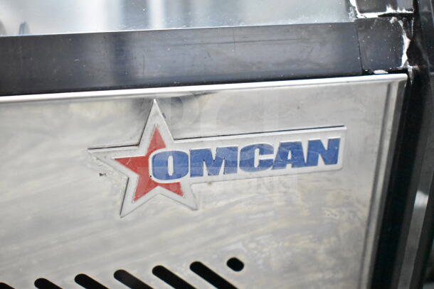 Omcan 27157 refrigerated display case, stainless steel exterior, 110V, 1 phase, visible Omcan logo emblem.