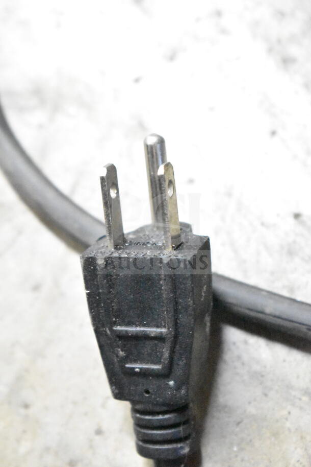Close-up of a black power plug for the Omcan 27157 Countertop Refrigerated Display Case, 110V, 1 Phase.