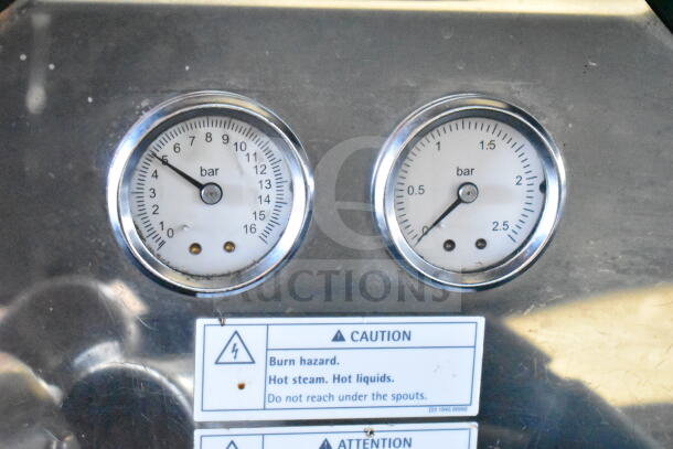 Schaerer Barista espresso machine gauges displaying pressure in bars, with caution label about burn hazards and hot steam.