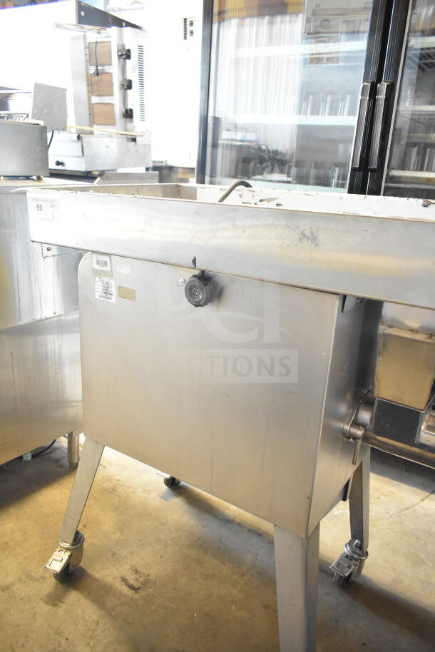 Sirman TC 32 MONTANA E commercial meat grinder, electric, 220V, 3-phase, stainless steel, on wheels. Minor wear visible.