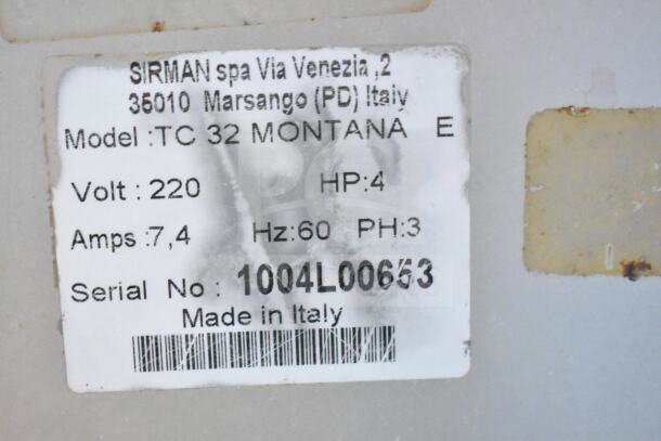 Label on Sirman TC 32 MONTANA E Meat Grinder, showing 220V, 3-phase, Model: TC 32 MONTANA E, Serial No: 1004L00653. Made in Italy.