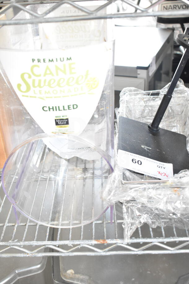 Seven assorted items including baskets and a slushie hopper. Visible label reads "Premium Cane Sweeeet Lemonade, Chilled."