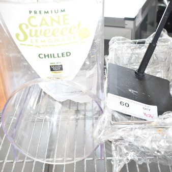 Seven assorted items including baskets and a slushie hopper. Visible label reads "Premium Cane Sweeeet Lemonade, Chilled."