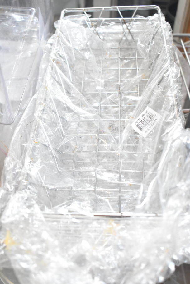 Metal wire basket wrapped in plastic, includes barcode label indicating product details. Part of a 7-item auction set.