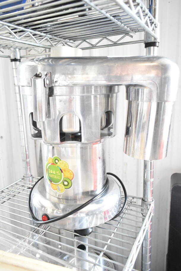 Commercial countertop citrus juicer, stainless steel, 110 volts, 1 phase. "100% natural" label on front.