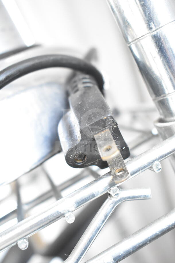 Commercial countertop citrus juicer plug, 110 volts, 1 phase, metal framework visible, used condition.