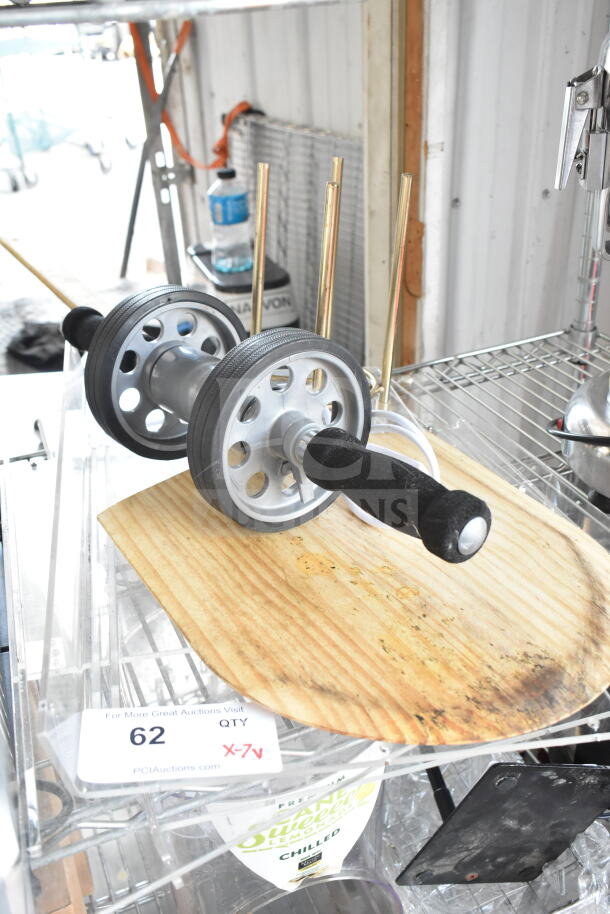 Seven-item lot featuring a wooden pizza paddle, steel rolling unit with handles, and cord. Auction label reads "62 QTY X-7v."
