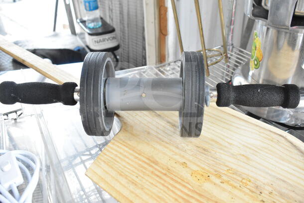 7-piece auction lot includes pizza paddle, exercise roller, and power cord. Features various materials and conditions.