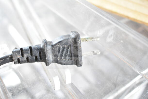 Close-up of a worn electrical plug for the Fellowes Saturn 3i 125 Pouch Laminator.