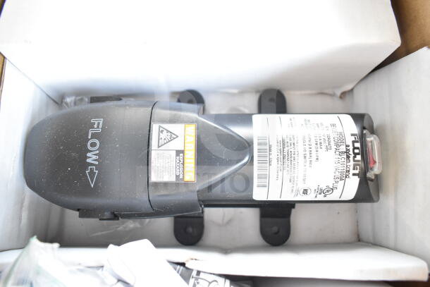 FloJet BLC101100A electric pump in box, showing label with model information and warning sticker.