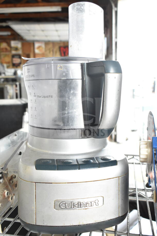 Cuisinart FP-8 food processor, 120V, in used condition, features liquid measurement markings and control buttons.