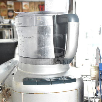 Cuisinart FP-8 food processor, 120V, in used condition, features liquid measurement markings and control buttons.