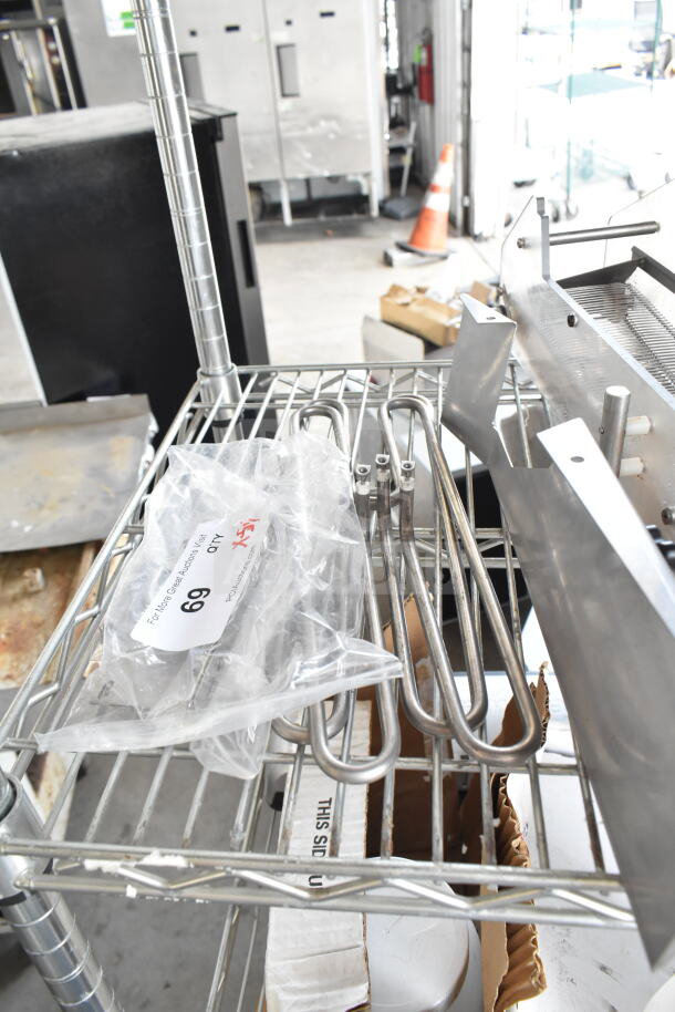Metal shelving with a ChocoVision Enrober part, heating elements, and a bag labeled "Lot 69 - 5 Times Your Bid!"