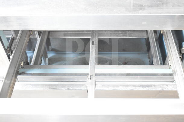 Delfield Commercial Sandwich Prep Table, stainless steel, with 4 drawers and over shelf. 115V, 1 phase. Visible interior structure.