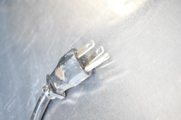Delfield sandwich salad prep table plug, showing a standard three-prong design on a metal surface. Condition: used.