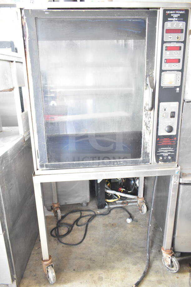 Henny Penny SCR-6 electric rotisserie oven on casters, used, featuring control panel and glass door, visible wear.