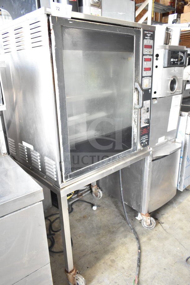 Henny Penny SCR-6 electric rotisserie oven on casters, stainless steel, digital controls, used condition.