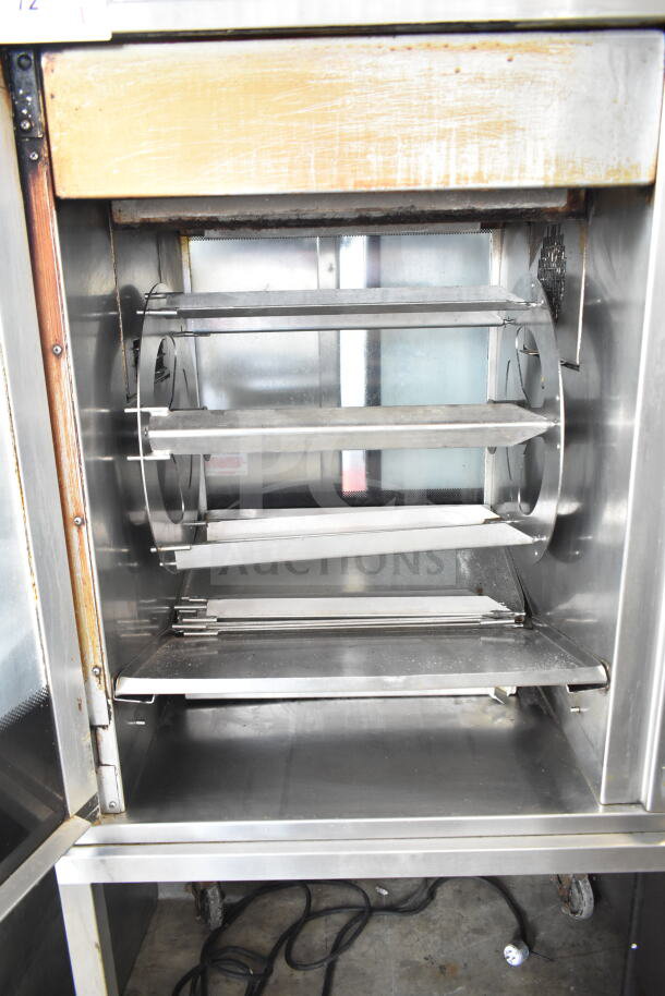 Henny Penny SCR-6 Commercial Electric Rotisserie Oven with stainless steel interior and commercial casters, in used condition.