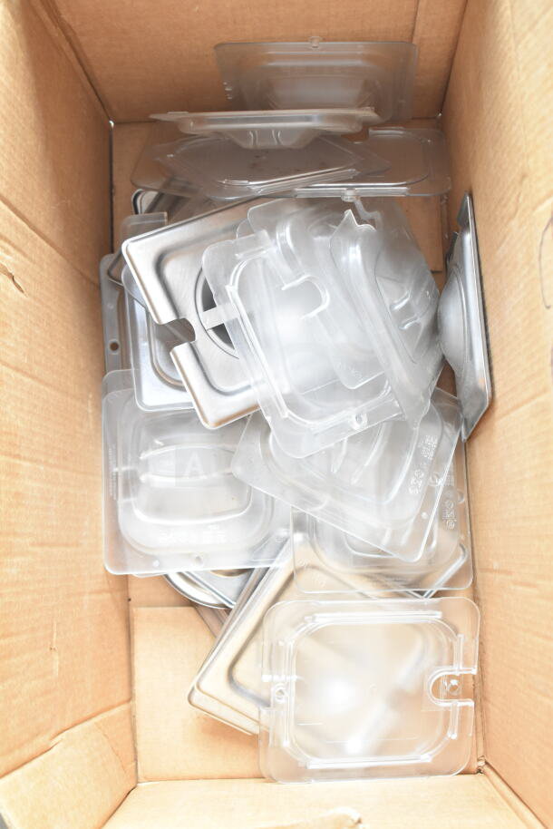 Cardboard box containing 34 various drop-in bin lids, clear plastic and stainless steel, new condition.