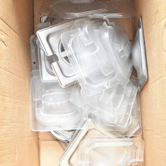 Cardboard box containing 34 various drop-in bin lids, clear plastic and stainless steel, new condition.
