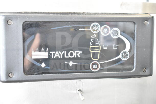 Taylor C709-33 commercial soft serve machine control panel, showing brand logo and operation icons.