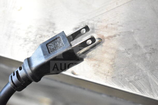 Close-up of a power plug on the Avantco 178GDC49HCB Reach In Cooler Merchandiser, 115 Volts, 1 Phase.