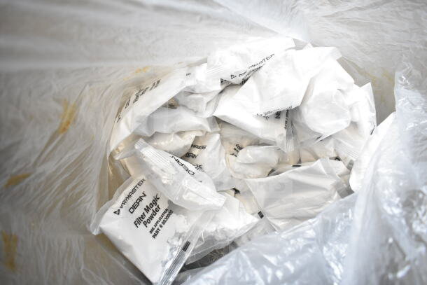 Plastic bag containing multiple Frymaster Dean Filter Magic Powder packets, used for deep fryer maintenance.