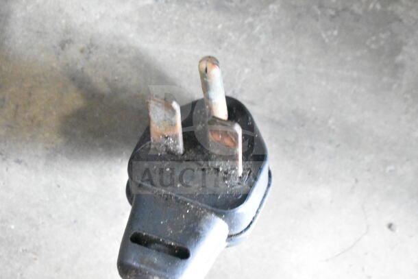 Close-up of the power plug for a Turbochef NGC rapid cook oven, showing wear and dust.