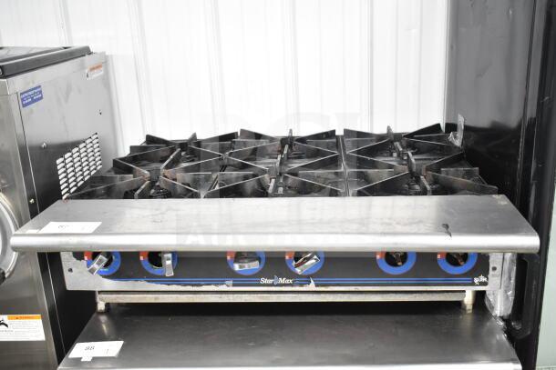 Star Max commercial countertop gas 6-burner range, used condition, metal dials with blue accents.