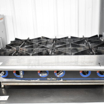 Star Max commercial countertop gas 6-burner range, used condition, metal dials with blue accents.